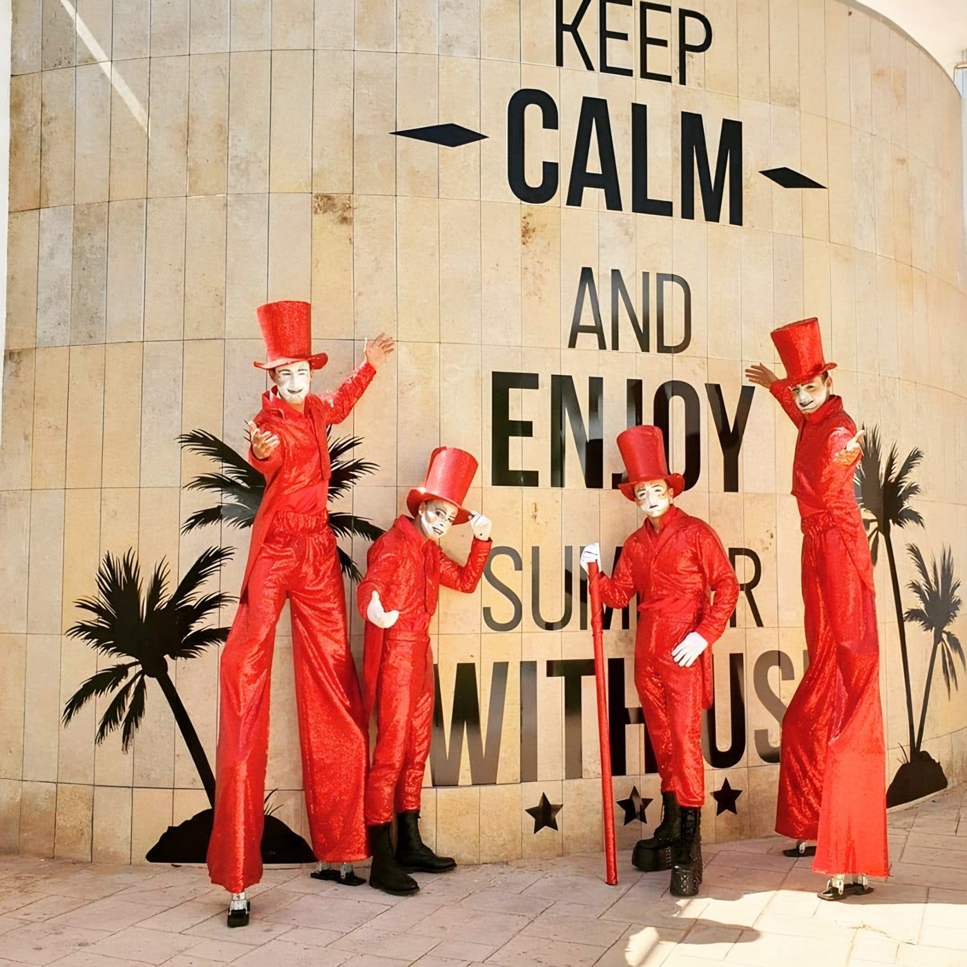 Red Suit - stilt walker quartet outdoors