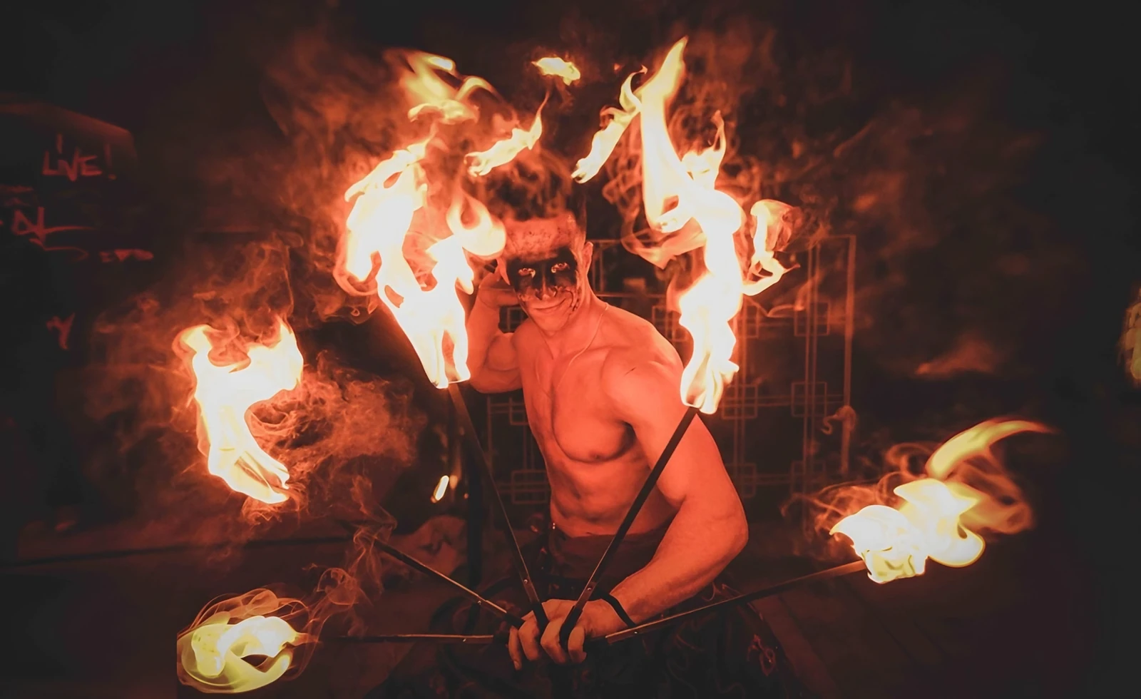 Fire breather in Marrakech with flaming fans at a party
